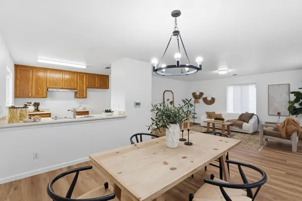 a view of a kitchen area with furniture and wooden floor