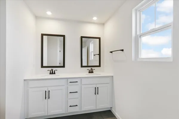 a bathroom with double sink and mirror