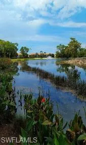 a view of a lake with houses in the back