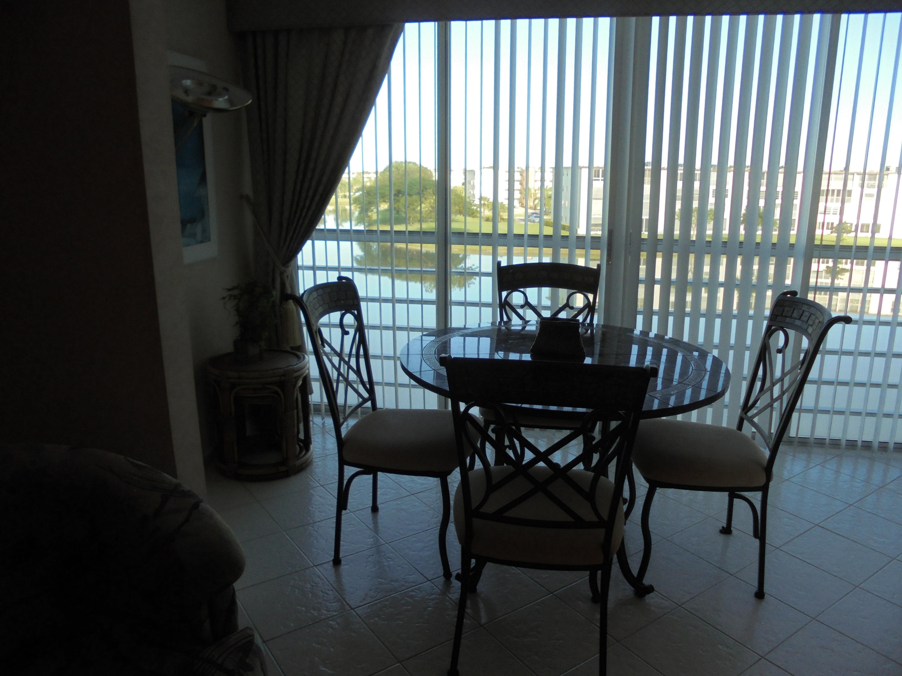 4037 Exeter C Boca Raton, FL 33434 - Photo 9 of 15 a view of a dining room with furniture wooden floor and a potted plant