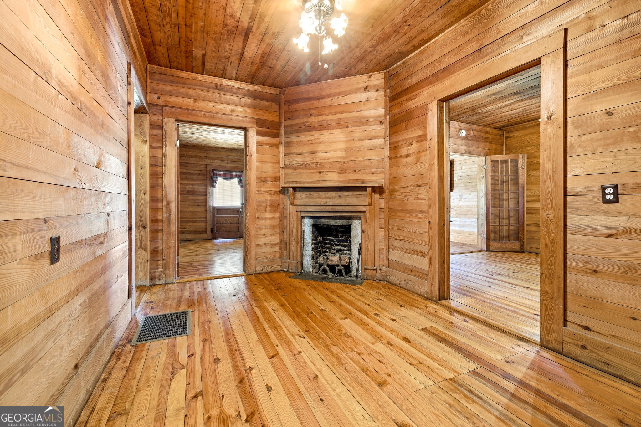 3213 Highway 326 Commerce, GA 30530 - Photo 14 of 40 a view of a livingroom with wooden floor and a fireplace