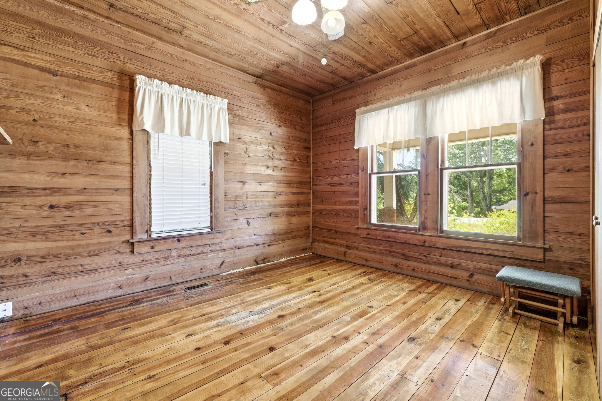 3213 Highway 326 Commerce, GA 30530 - Photo 17 of 40 a view of an empty room with a window and wooden floor