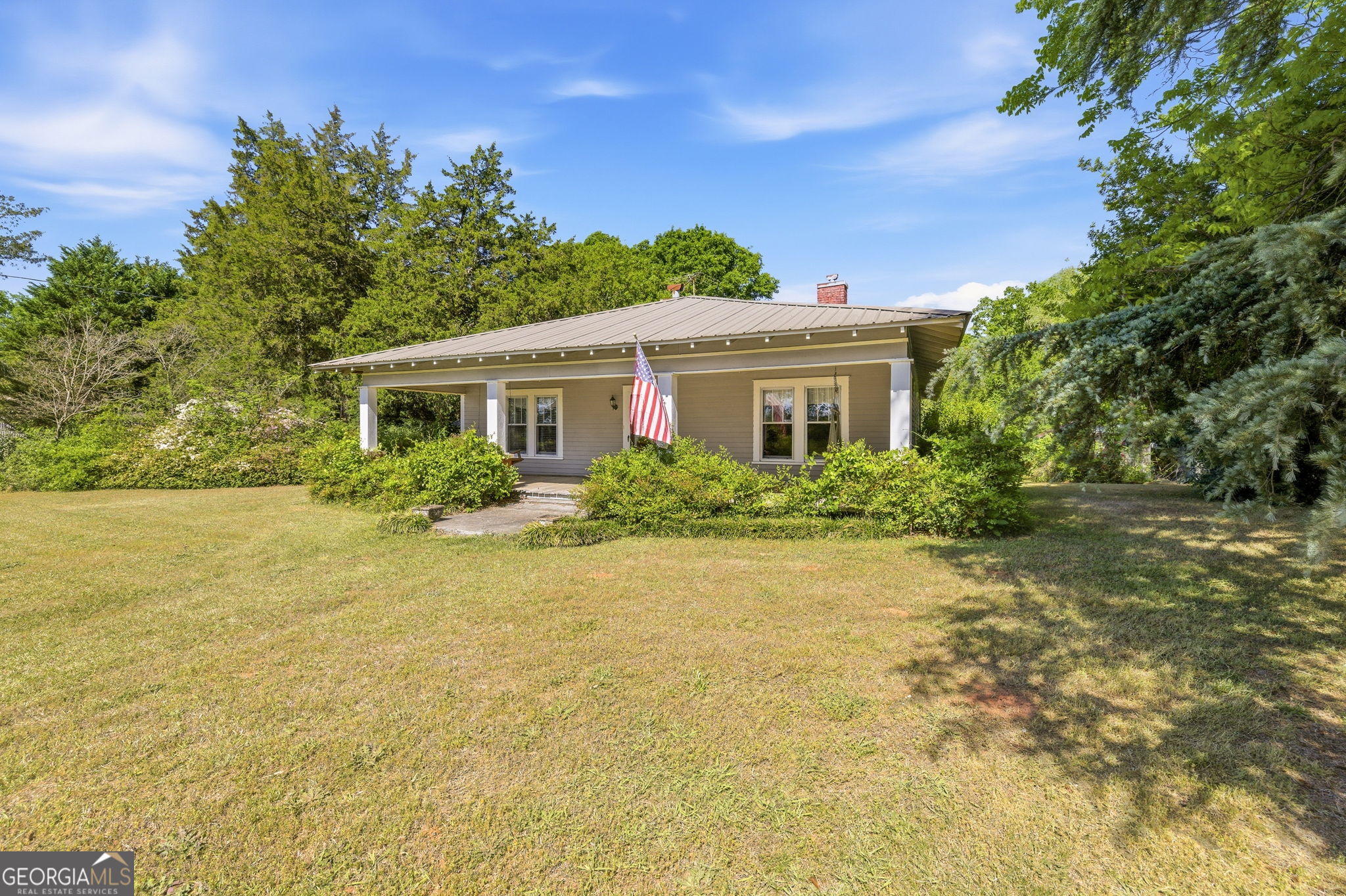 3213 Highway 326 Commerce, GA 30530 - Photo 2 of 40 a front view of a house with a yard and trees