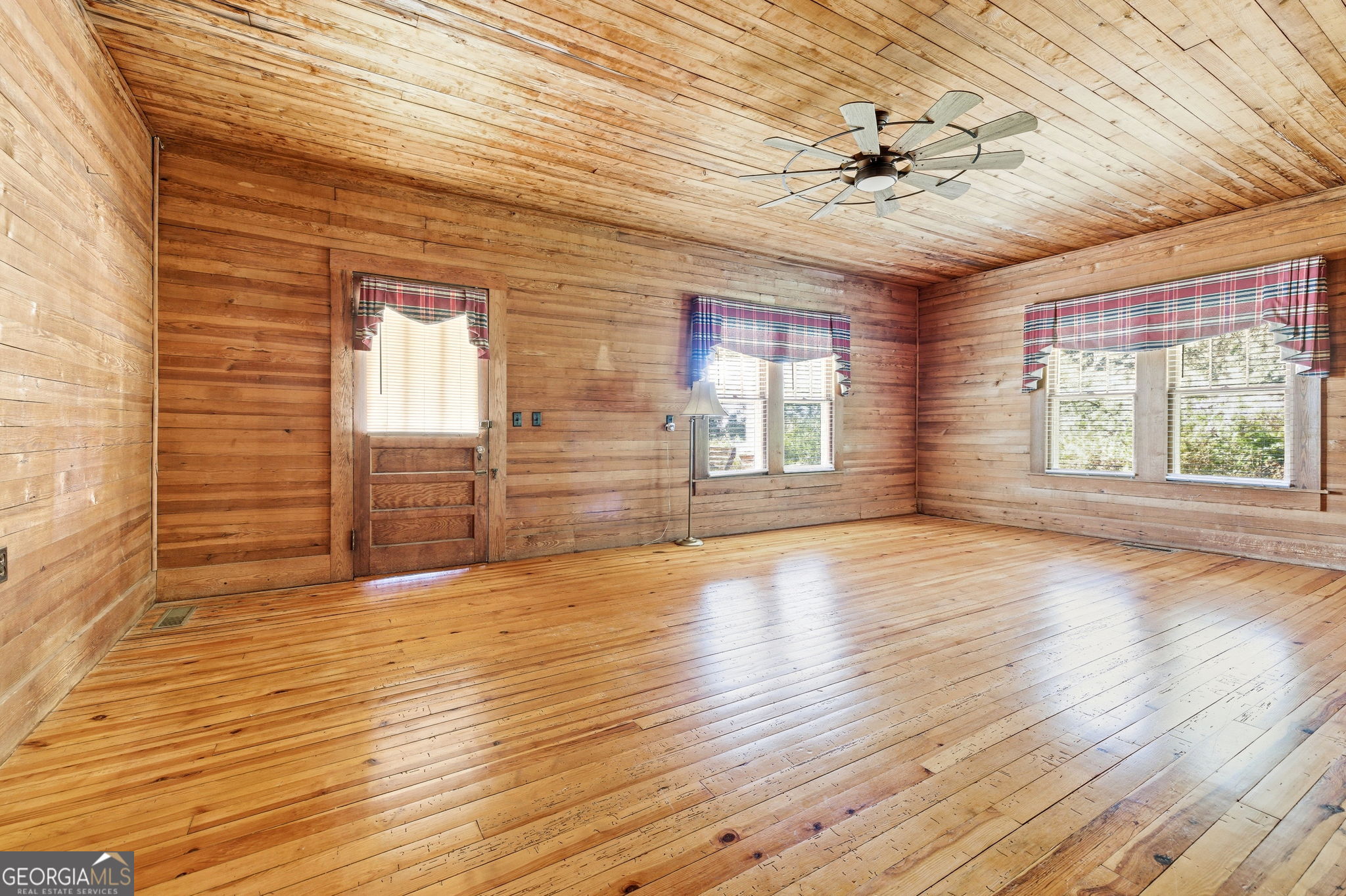 3213 Highway 326 Commerce, GA 30530 - Photo 6 of 40 a view of an empty room with a window and wooden floor