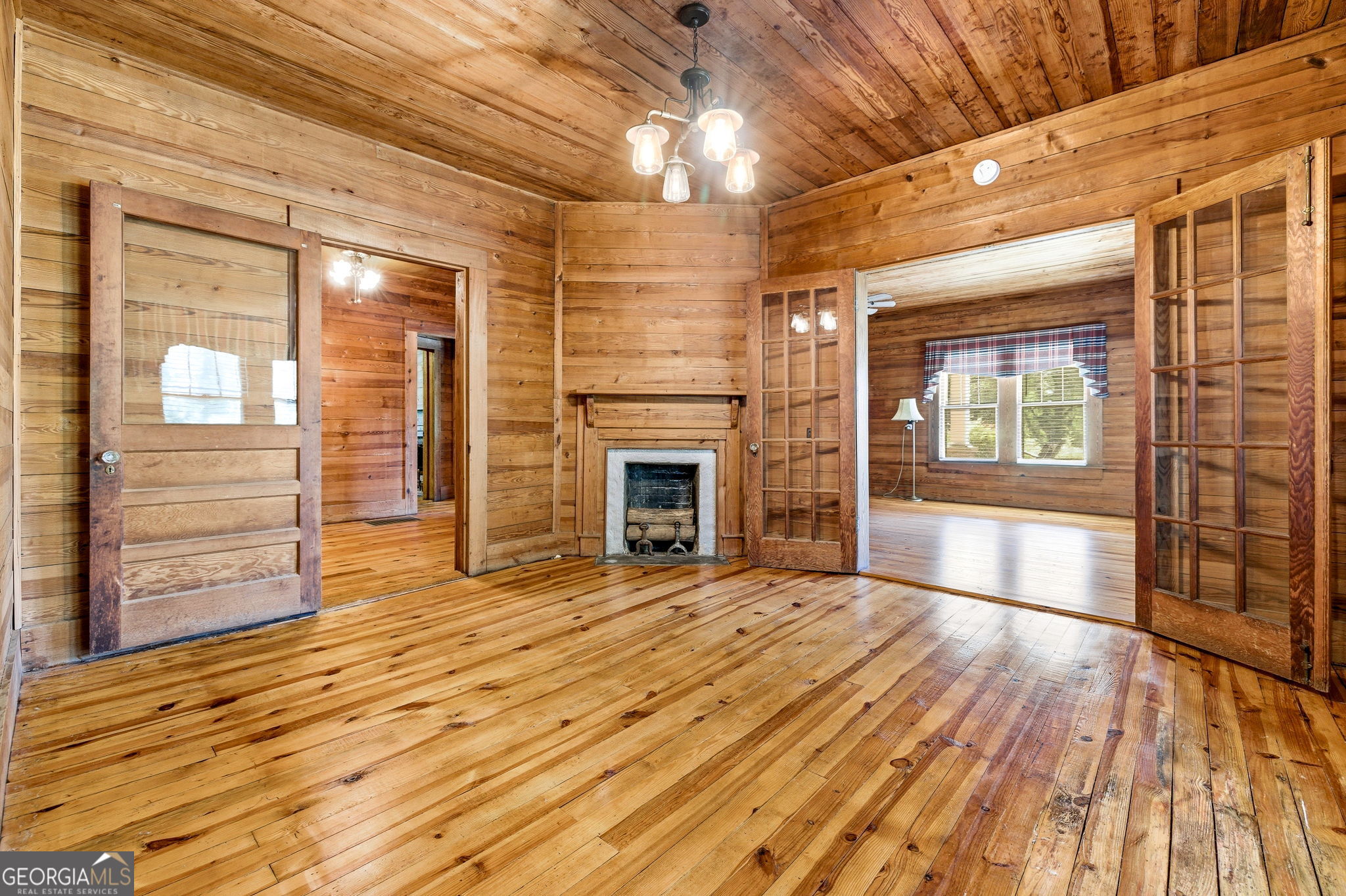 3213 Highway 326 Commerce, GA 30530 - Photo 10 of 40 a view of an empty room with wooden floor fireplace and a window
