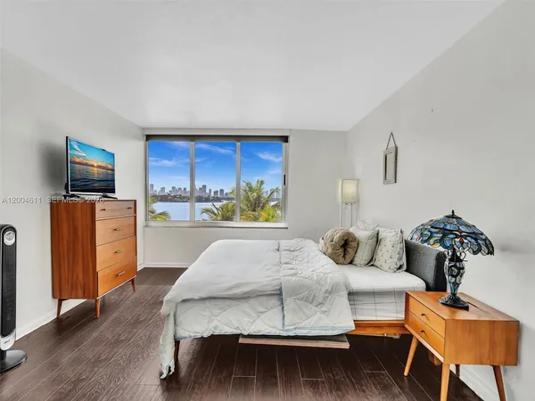 a bedroom with a bed and a television