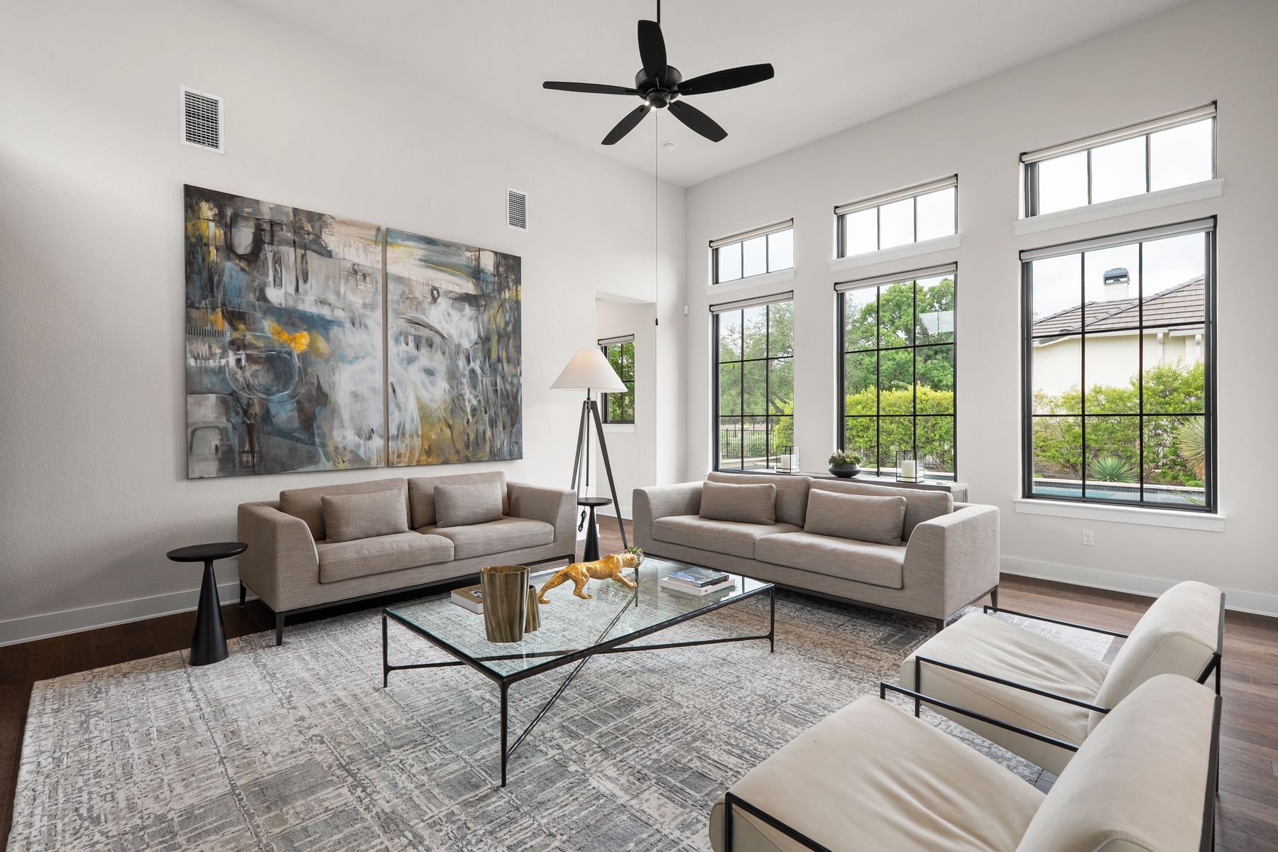 1106 Flint Ridge Trail Georgetown, TX 78628 - Photo 18 of 38 Tall windows and soaring ceilings define this light-filled living space, offering views of the lush greenery outside.
