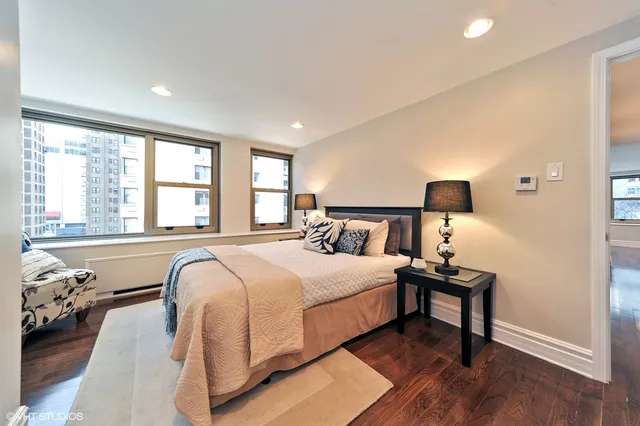 a bedroom with a bed and a night stand