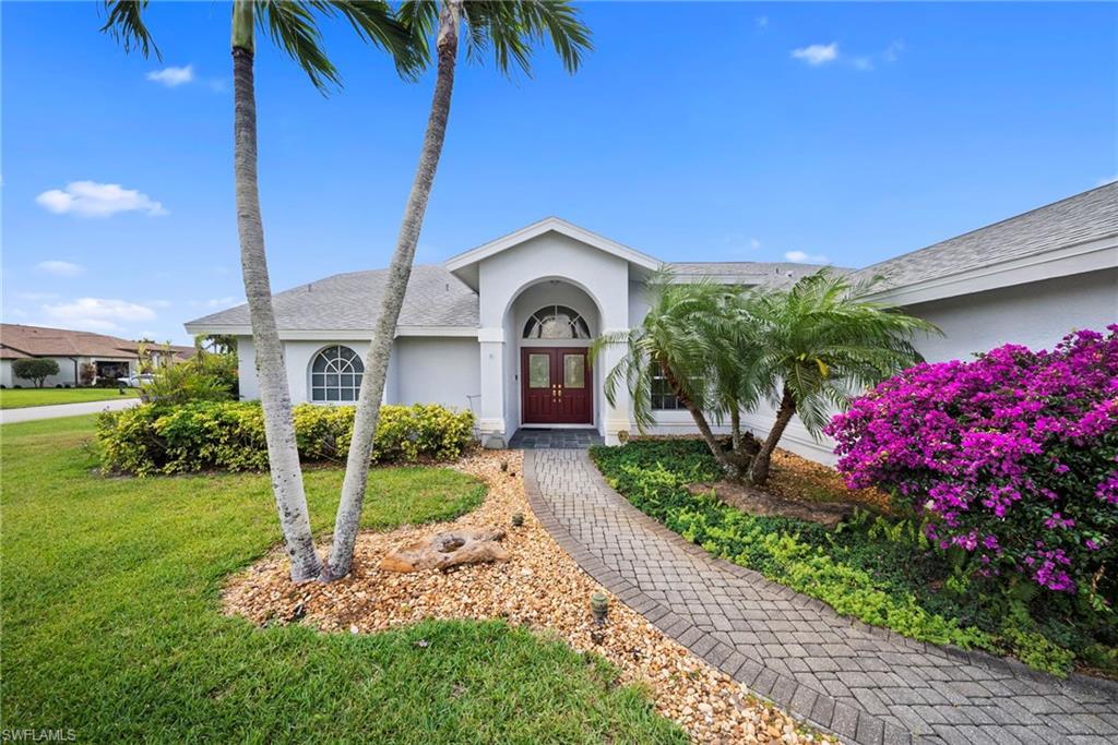 3971 Spring Garden Lane Estero, FL 33928 - Photo 31 of 31 a front view of a house with a garden