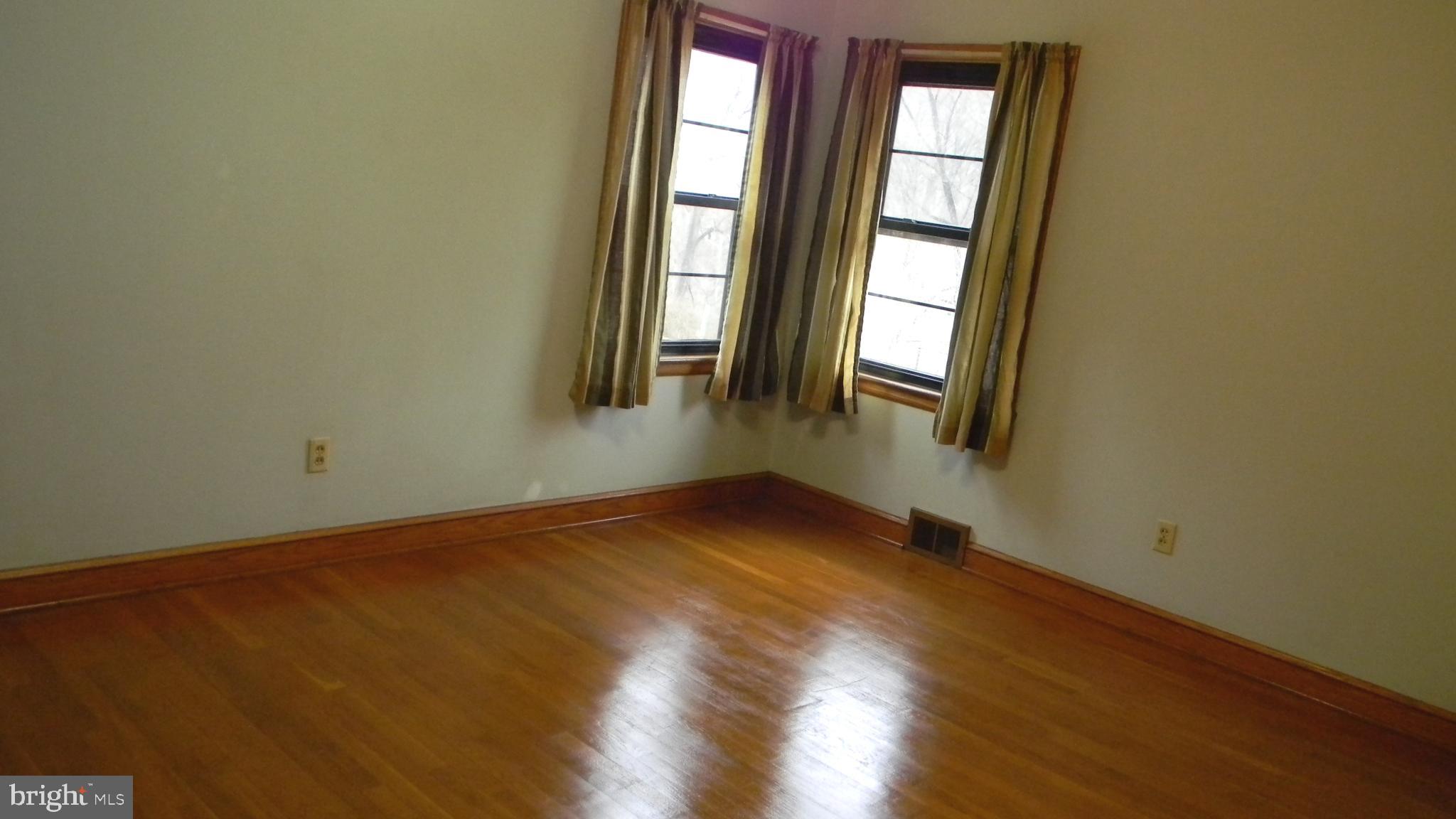 6688 Brocks Gap Road Broadway, VA 22815 - Photo 43 of 81 an empty room with wooden floor and windows