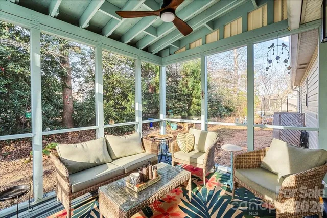 a living room with furniture and a floor to ceiling window