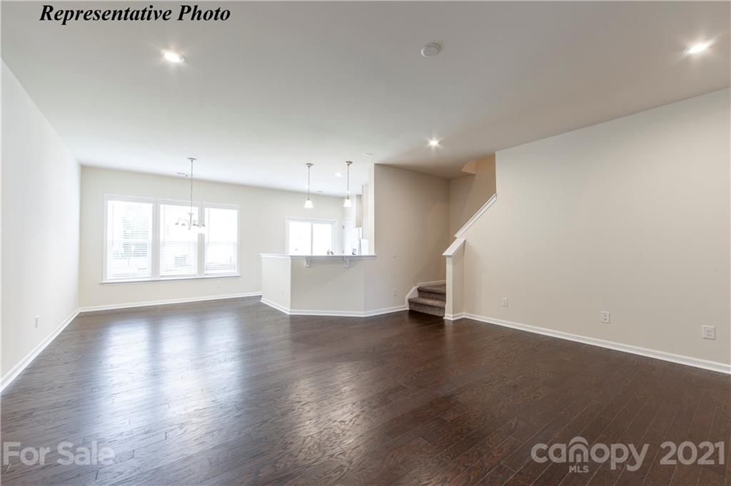 715 Elders Story Road, Unit 344 Fort Mill, SC 29708 - Photo 5 of 19 a view of an empty room with a window and wooden floor