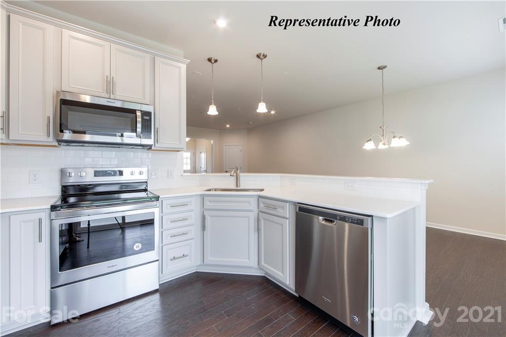 715 Elders Story Road, Unit 344 Fort Mill, SC 29708 - Photo 7 of 19 a kitchen with stainless steel appliances a stove a sink and white cabinets