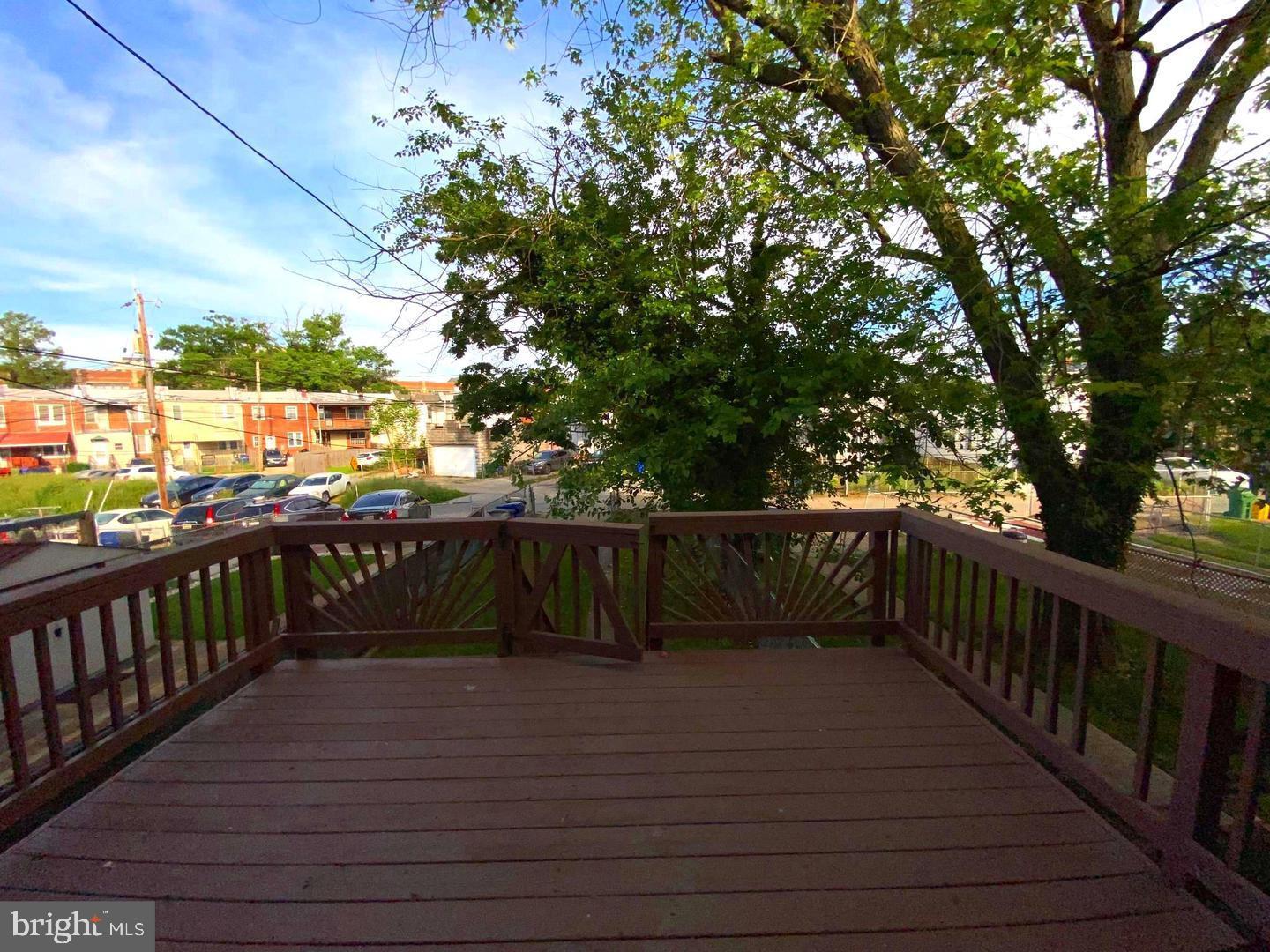 41 North Kossuth Street Baltimore, MD 21229 - Photo 11 of 30 a view of balcony with wooden floor and fence