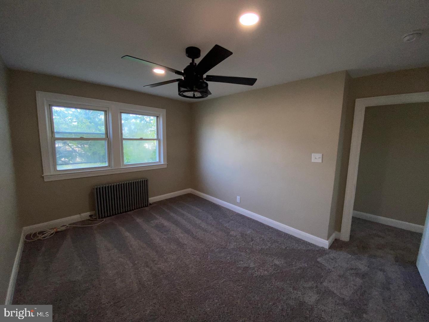 41 North Kossuth Street Baltimore, MD 21229 - Photo 21 of 30 an empty room with windows and fan