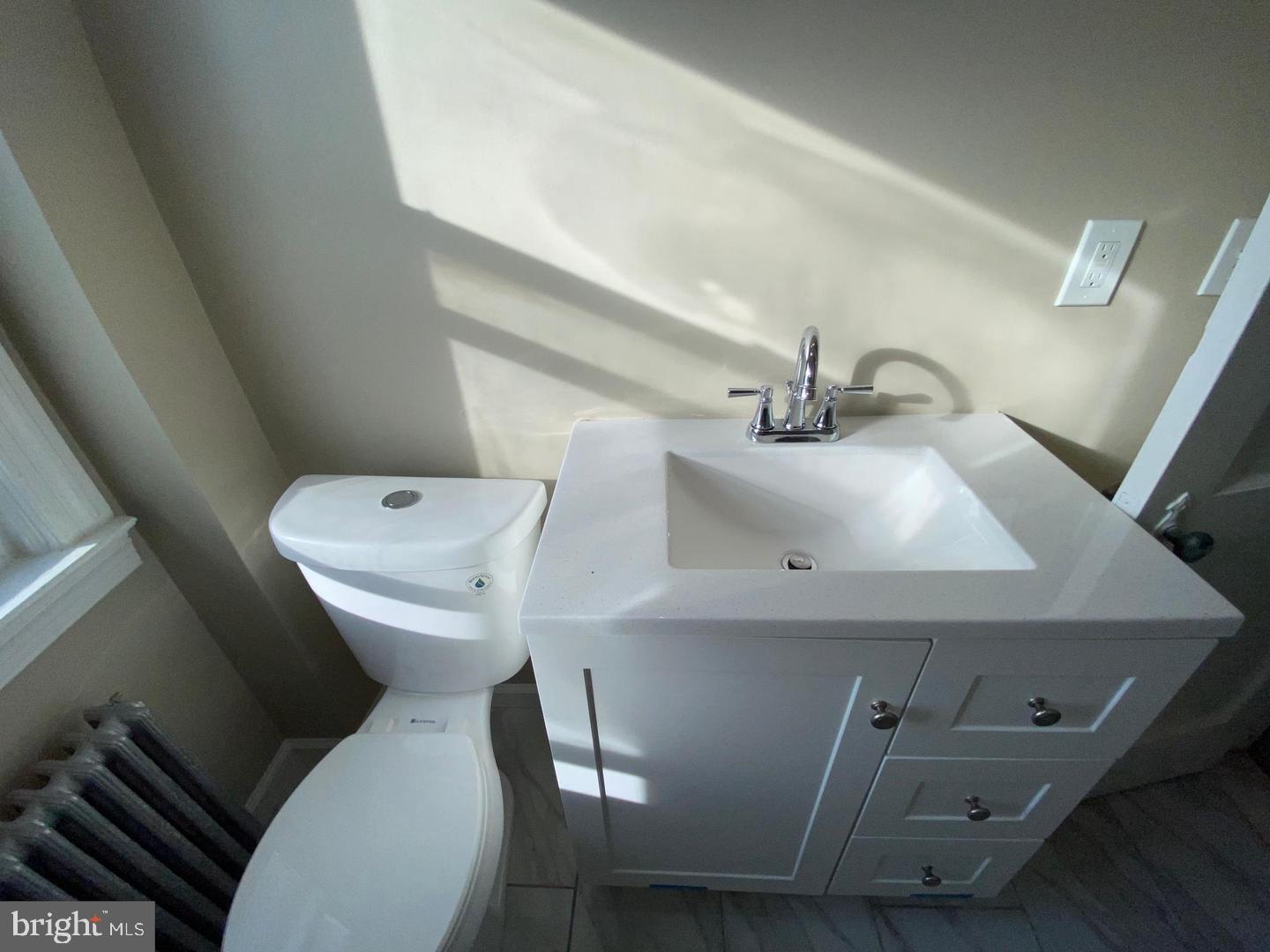 41 North Kossuth Street Baltimore, MD 21229 - Photo 25 of 30 a white toilet sitting next to a sink