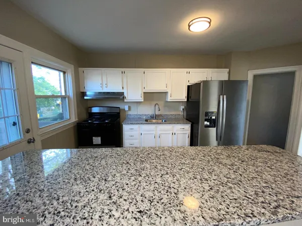a kitchen with refrigerator and window