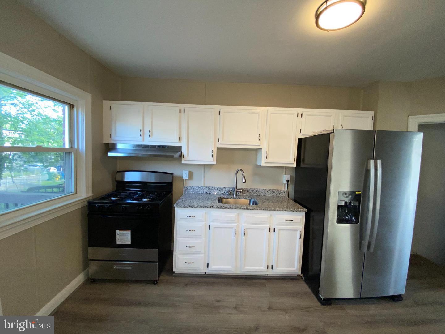 41 North Kossuth Street Baltimore, MD 21229 - Photo 8 of 30 a kitchen with a refrigerator stove and sink