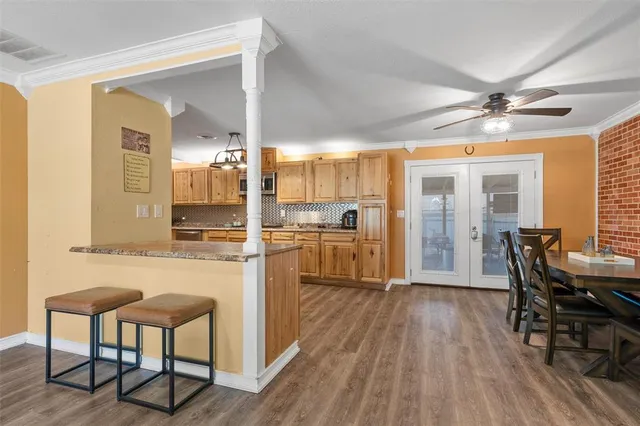 a kitchen with refrigerator cabinets and wooden floor