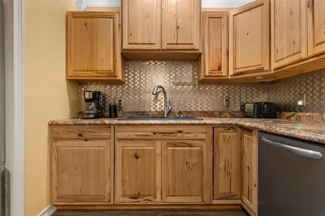 a kitchen with stainless steel appliances granite countertop a sink dishwasher a cabinets and wooden floor
