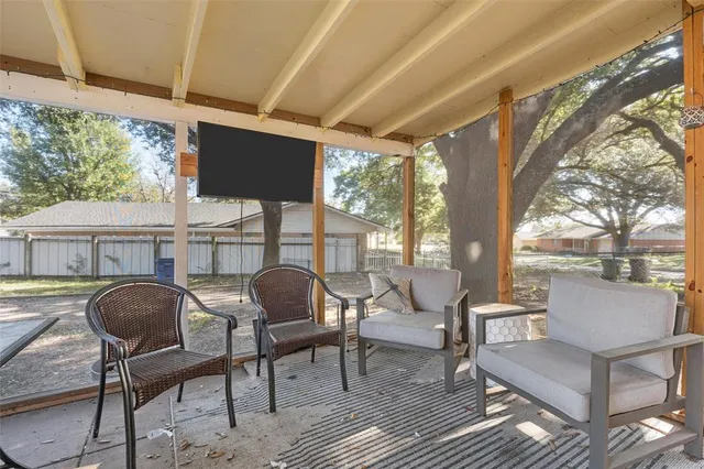 a view of a porch with furniture and a yard