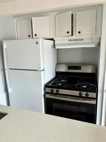a kitchen with a stove and a refrigerator