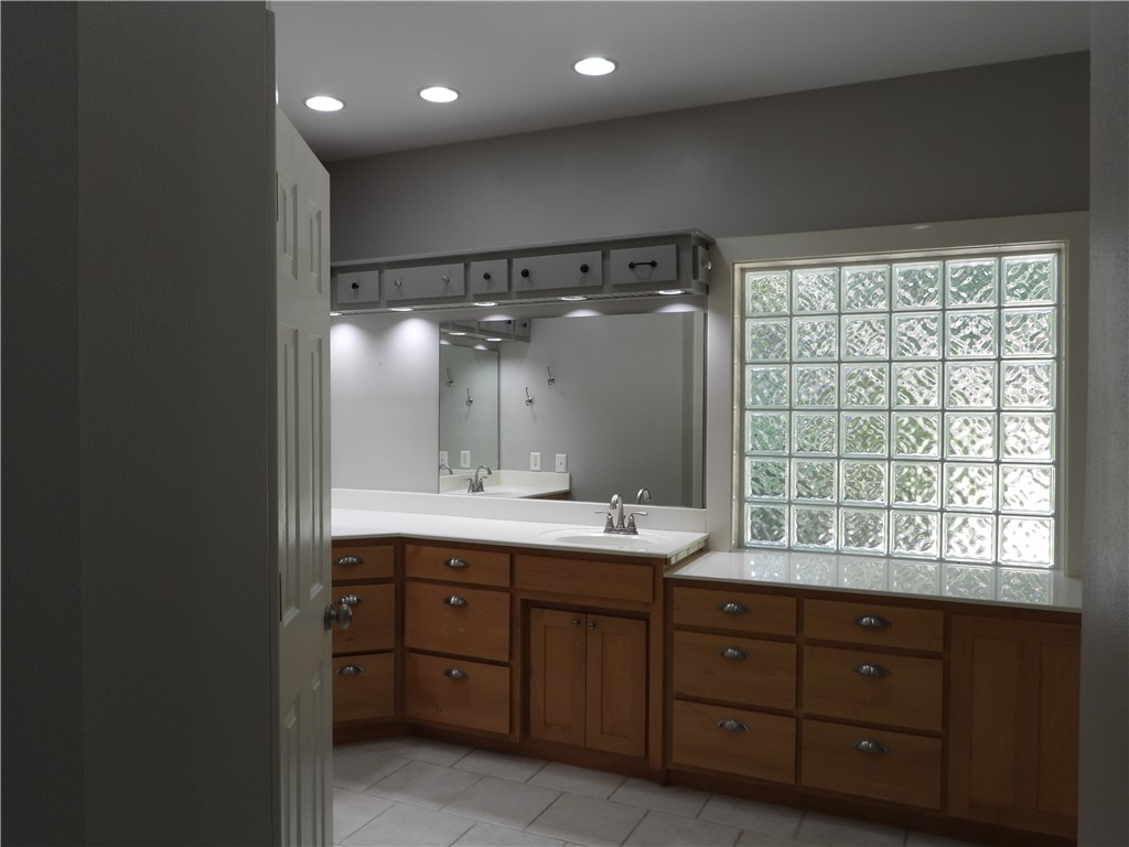 19489 Oak Circle Springdale, AR 72764 - Photo 28 of 58 Dual vanity area with wood cabinetry and white countertops