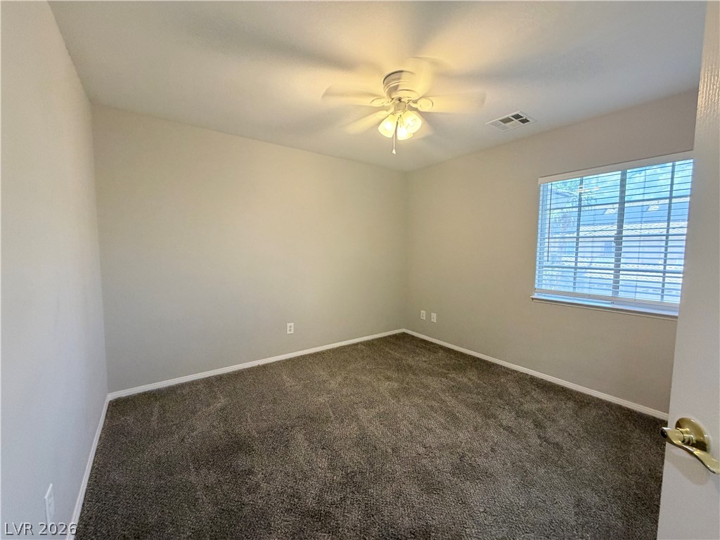 6116 Rabbit Track Street Las Vegas, NV 89130 - Photo 16 of 28 Well-lit and carpeted, this space offers comfort and quiet relaxation.