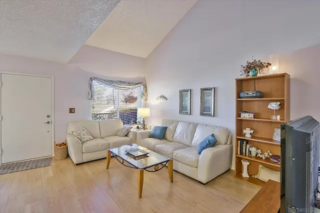 a living room with furniture cabinets and a window