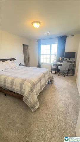 a bedroom with bed and window