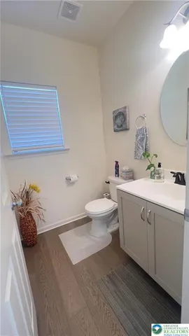 a bathroom with a sink mirror and toilet