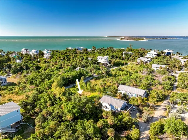 an aerial view of a houses with a lake view
