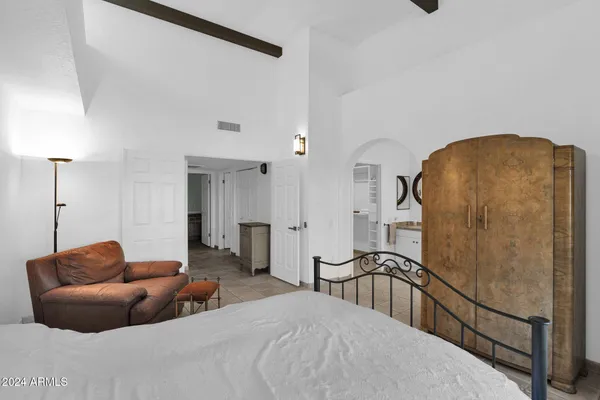 a bedroom with furniture and a window