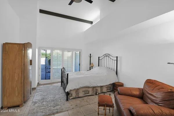 a bedroom with furniture and a window