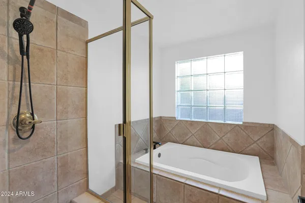 a bathroom with a tub and a window