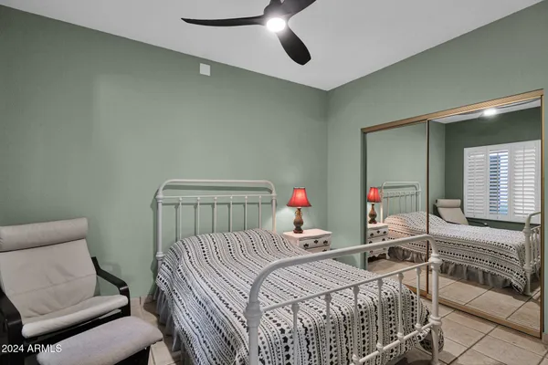 a bedroom with a bed and a chair