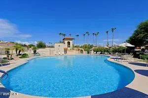 a view of a swimming pool and lounge chairs