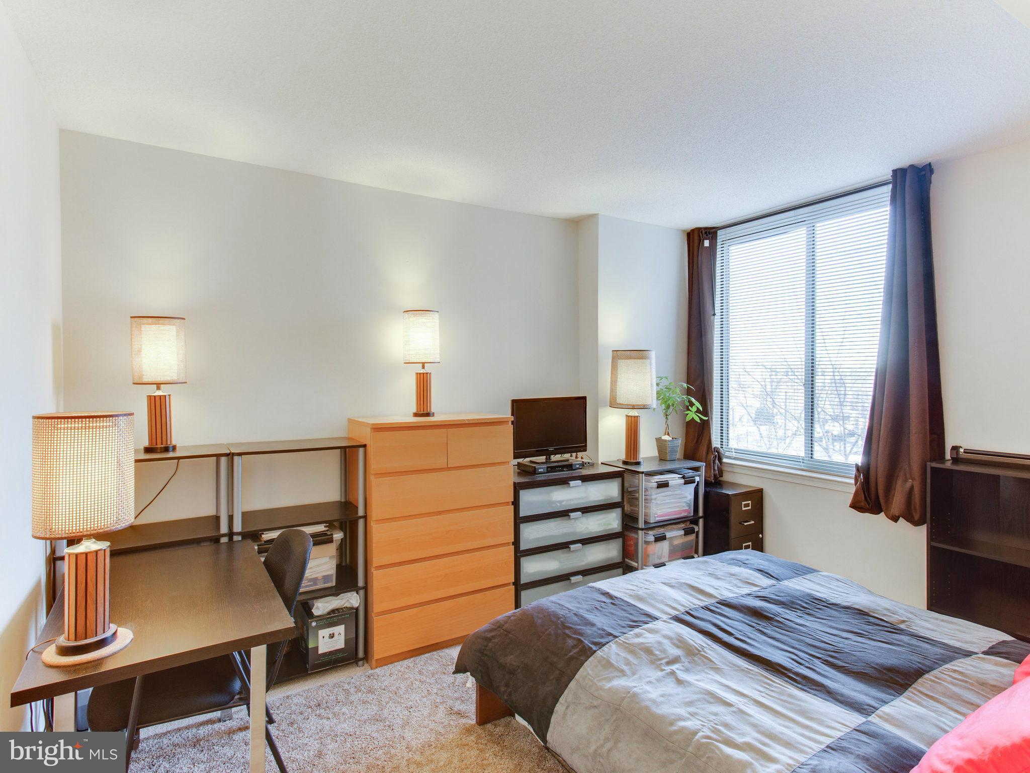 851 North Glebe Road, Unit 403 Arlington, VA 22203 - Photo 11 of 28 a bedroom with a bed and furniture with window