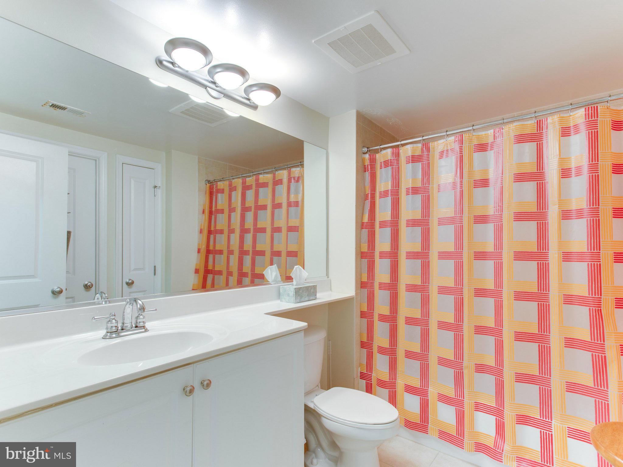 851 North Glebe Road, Unit 403 Arlington, VA 22203 - Photo 13 of 28 a bathroom with a sink a toilet and shower