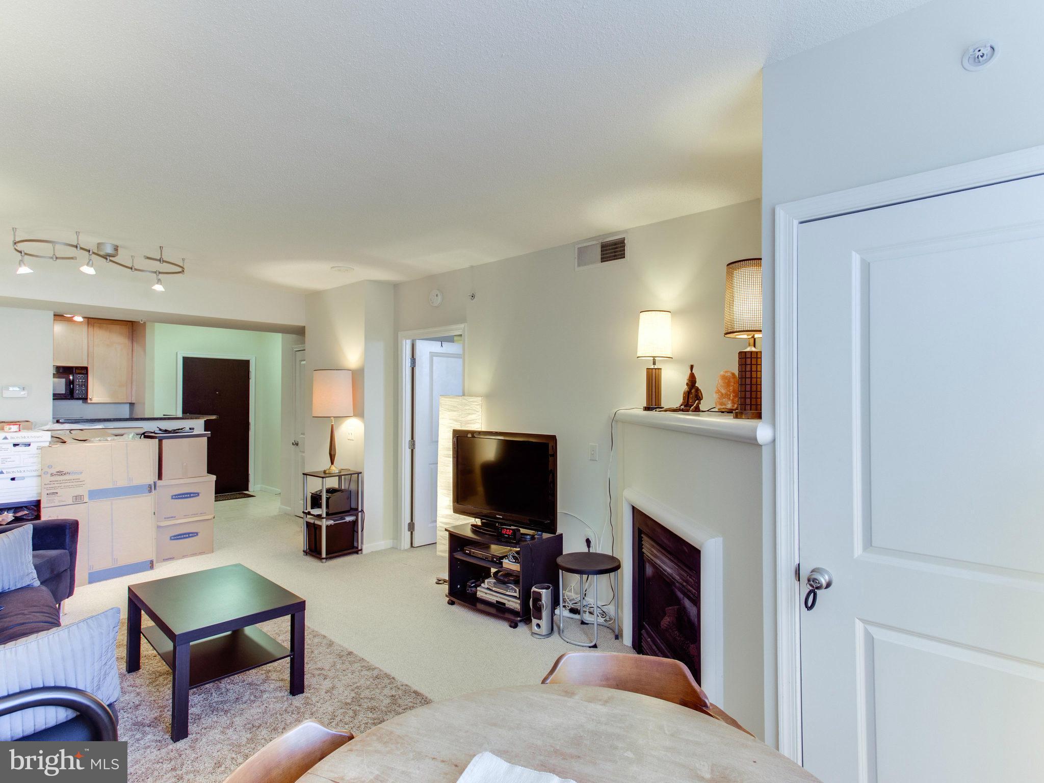 851 North Glebe Road, Unit 403 Arlington, VA 22203 - Photo 3 of 28 a living room with furniture and a flat screen tv