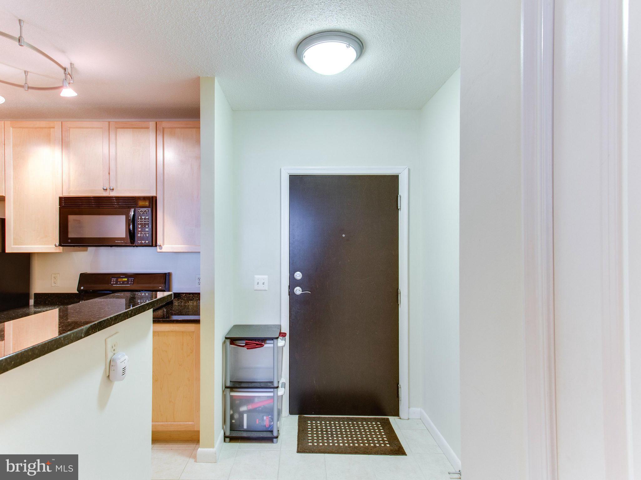 851 North Glebe Road, Unit 403 Arlington, VA 22203 - Photo 7 of 28 a kitchen with cabinets and a counter top space