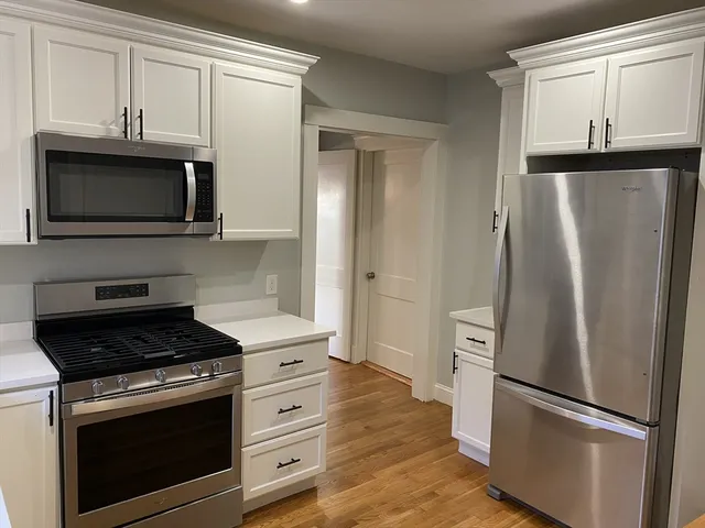 a kitchen with granite countertop cabinets and steel stainless steel appliances