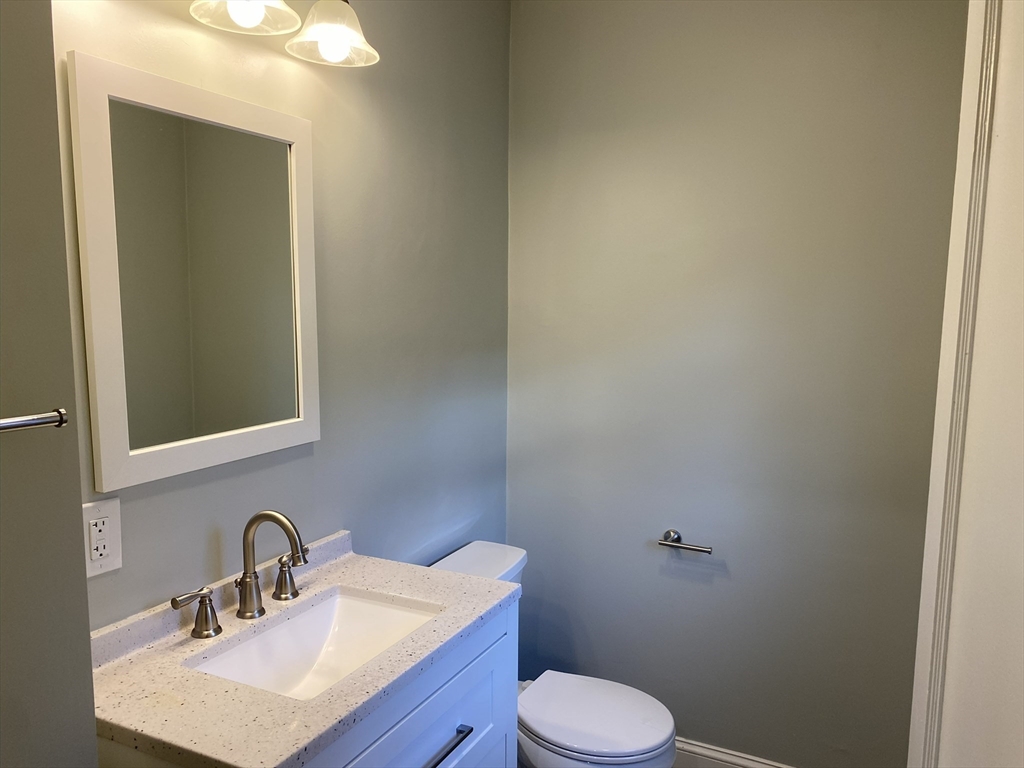 281 Belgrade Avenue, Unit 3 Boston, MA 02131 - Photo 6 of 14 a bathroom with a sink a toilet and mirror