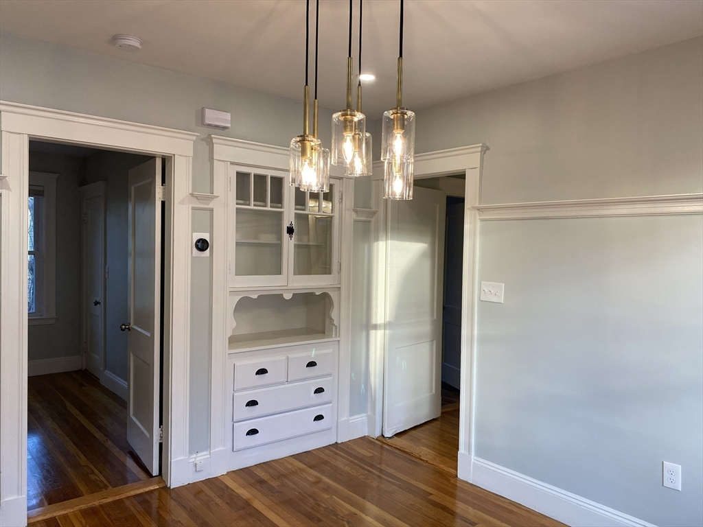 281 Belgrade Avenue, Unit 3 Boston, MA 02131 - Photo 9 of 14 a view of a hallway with wooden floor