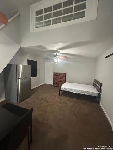 a view of a yard in front of a house with large trees