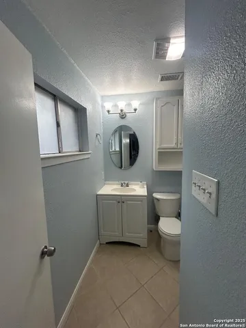 a bathroom with a sink toilet and mirror