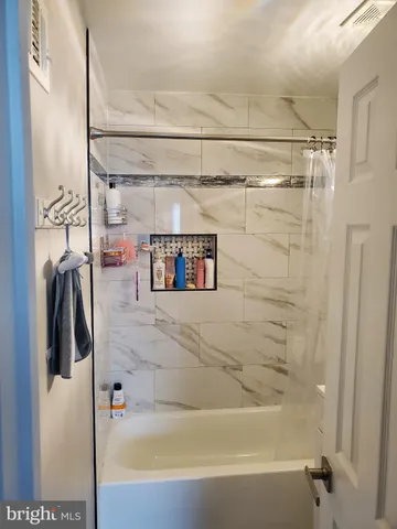 a bathroom with a shower and a tub