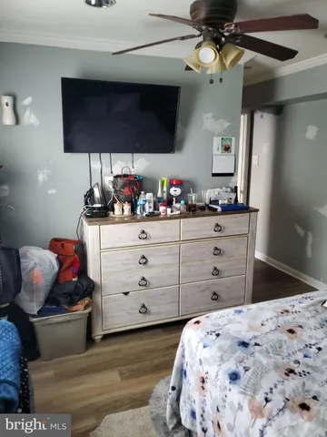 a bedroom with a bed and a television