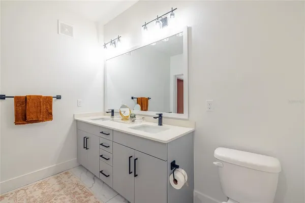 a bedroom with a bed and a view of bathroom