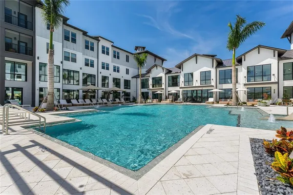 a view of a patio with swimming pool table and chairs